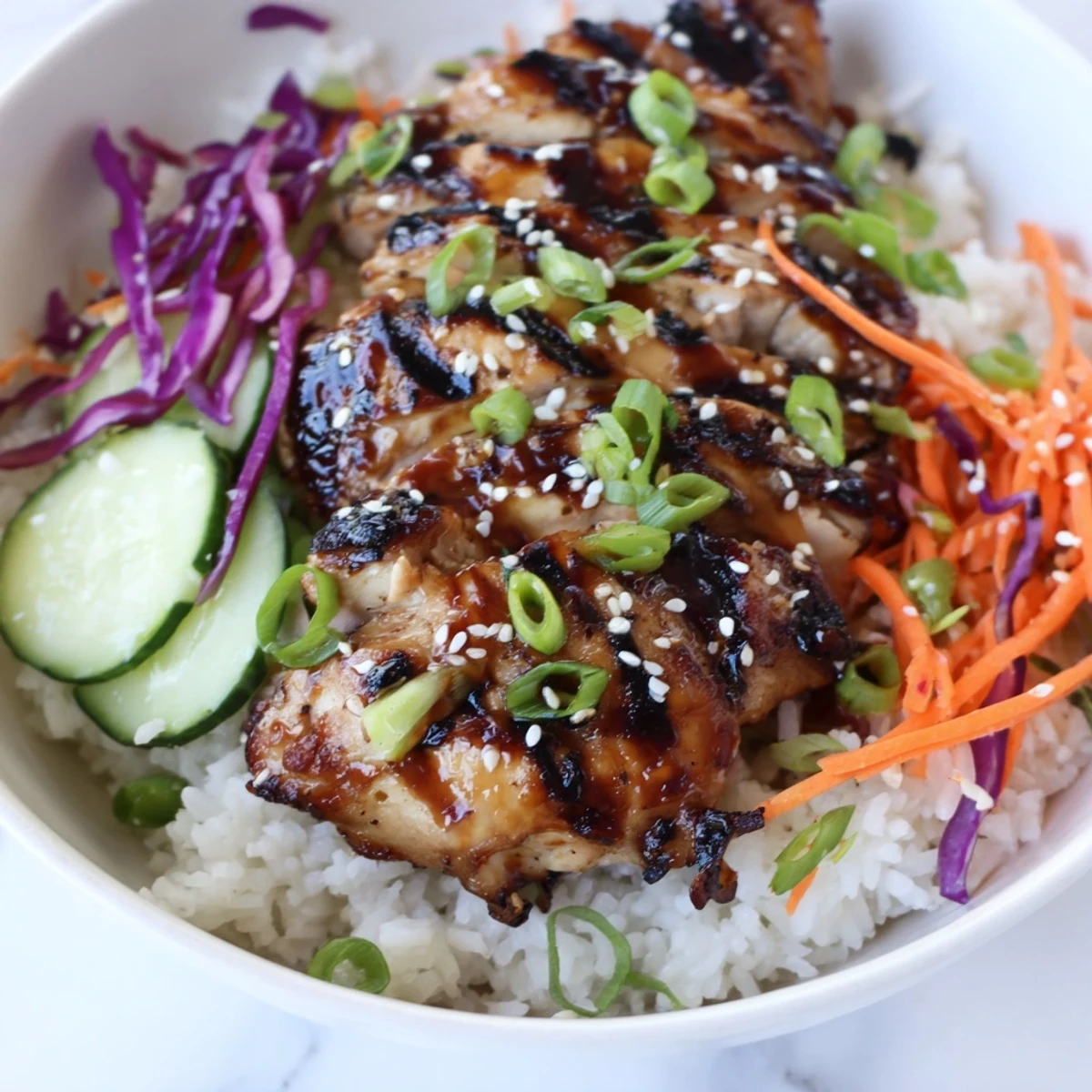 Juicy Korean BBQ chicken bowl with grilled thighs over fluffy rice and colorful vegetables
