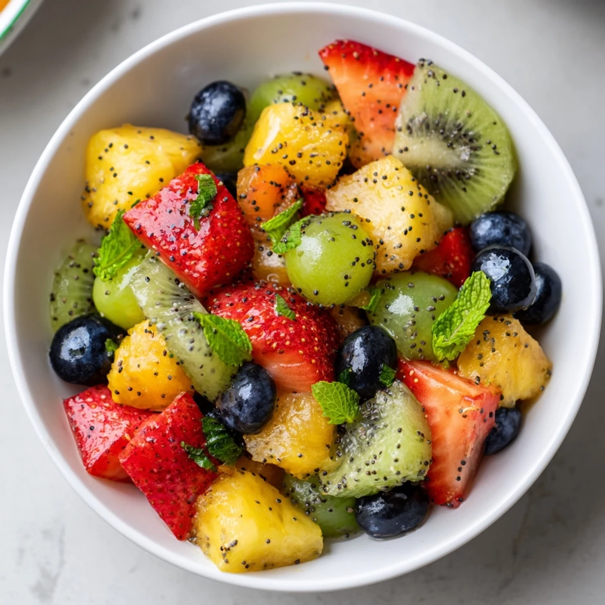 Refreshing Easter fruit salad in glass bowl featuring vibrant blueberries, grapes, and mandarin oranges