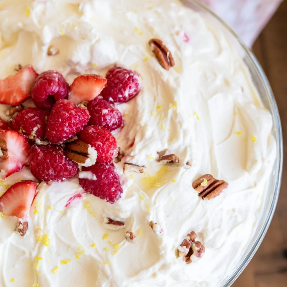 Creamy keto cheesecake fluff topped with fresh berries in small glass bowls