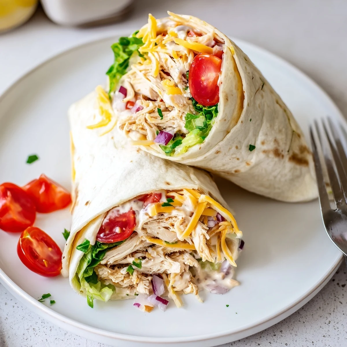 Cheesy Garlic Chicken Wraps with melted cheddar, soft tortilla and crisp lettuce