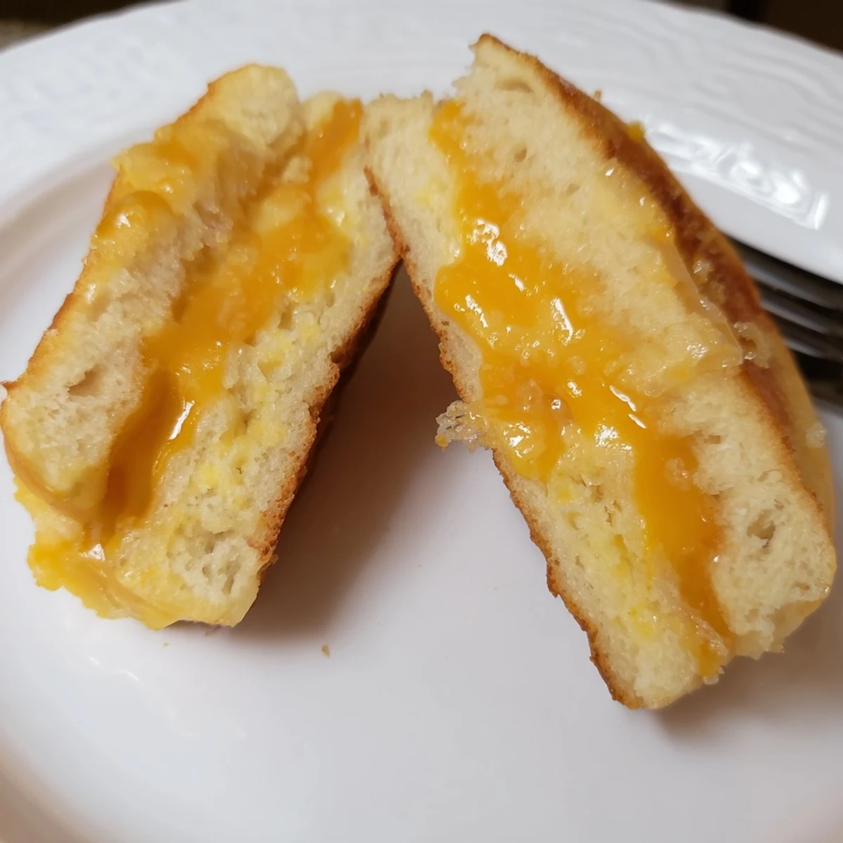 Warm Mini Grilled Cheese Hawaiian Rolls layered with sharp cheddar, perfect party bites
