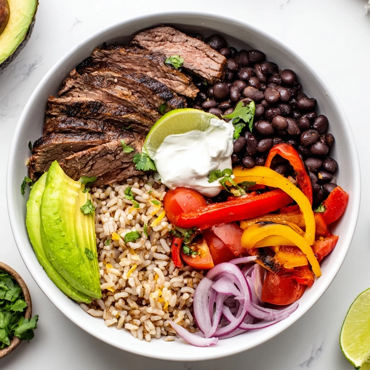 Grilled steak, black beans, sauteed peppers assemble into Steak Fajita Power Bowls.