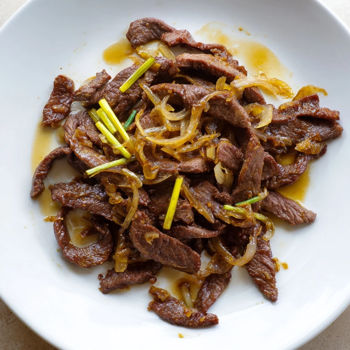 Wok-tender beef strips with sweet onions glazed in savory brown Chinese sauce
