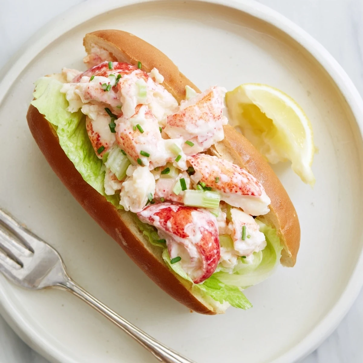 Fresh Maine style lobster roll salad served in buttery grilled New England bun