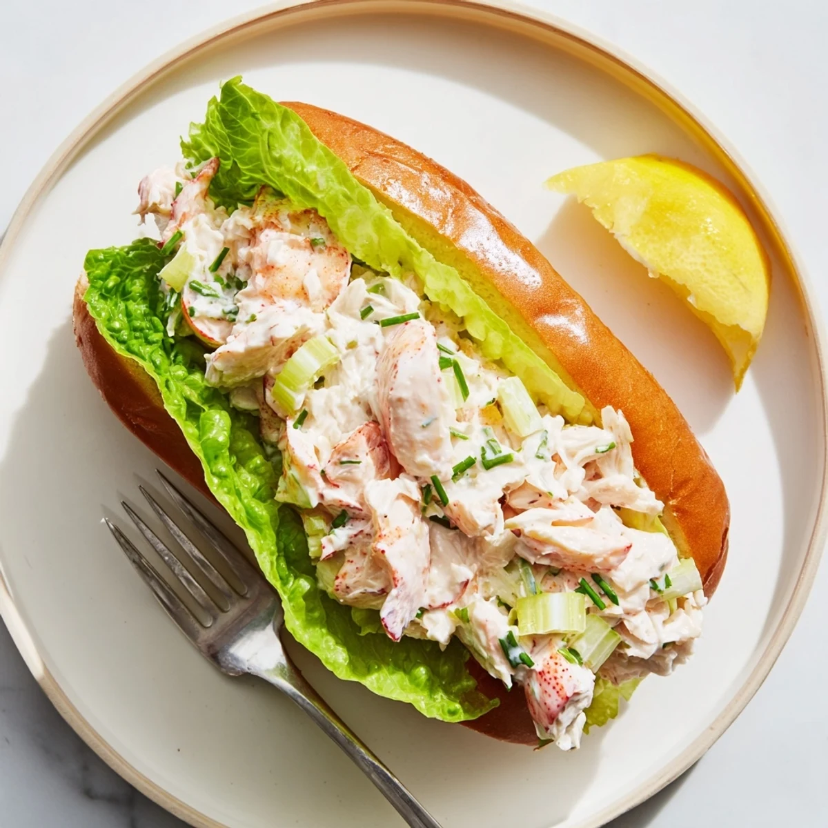 Golden toasted split-top bun piled high with creamy Maine style lobster roll meat