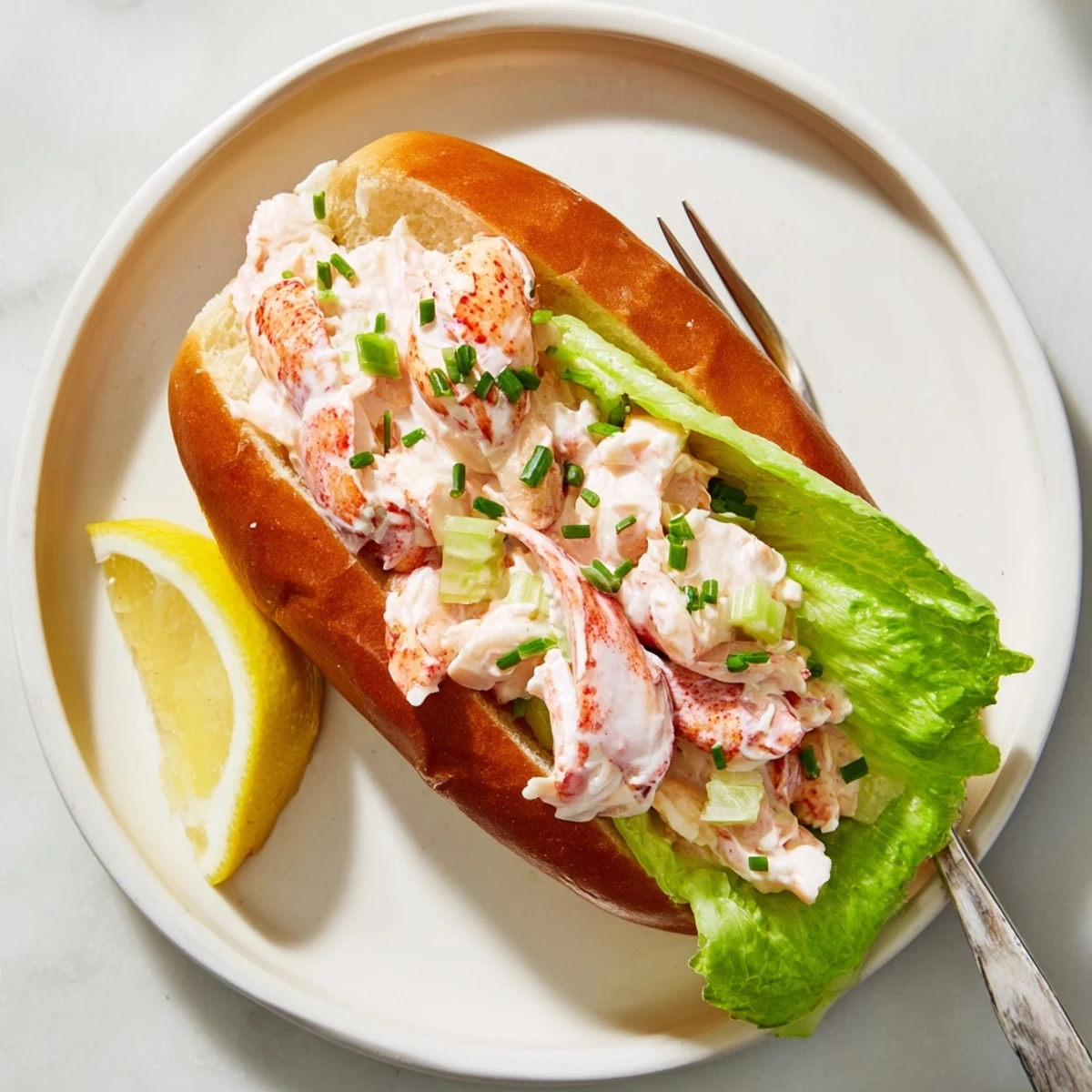 Classic Maine style lobster roll featuring tender chunks in mayonnaise on toasted bun