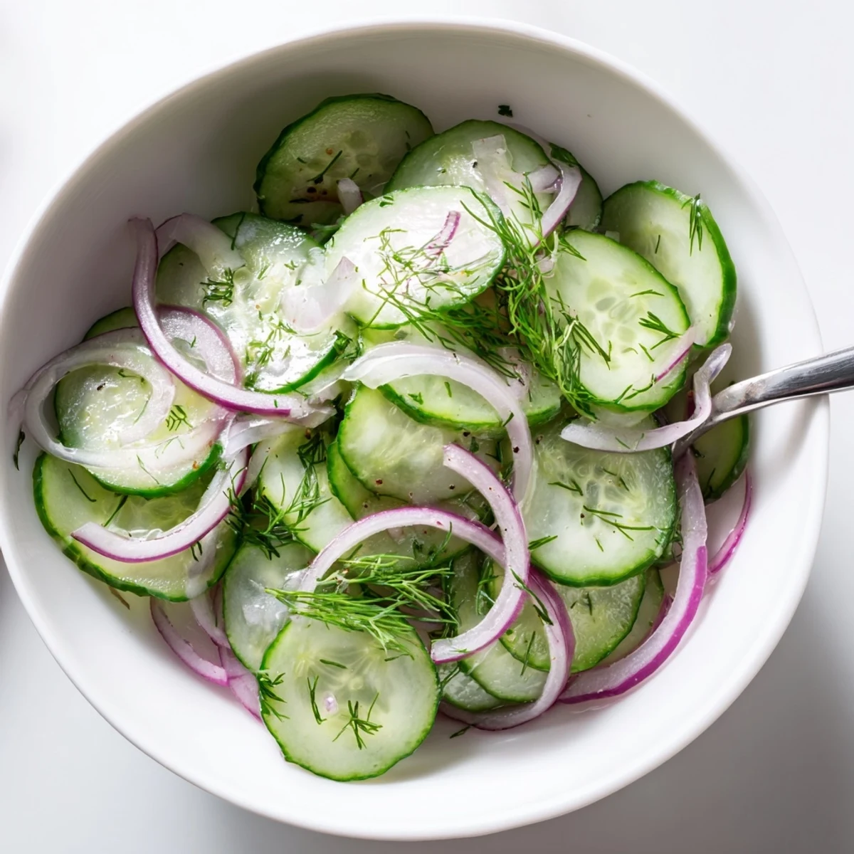 Bright Cucumber Salad with thinly sliced red onion, refreshing summer side.