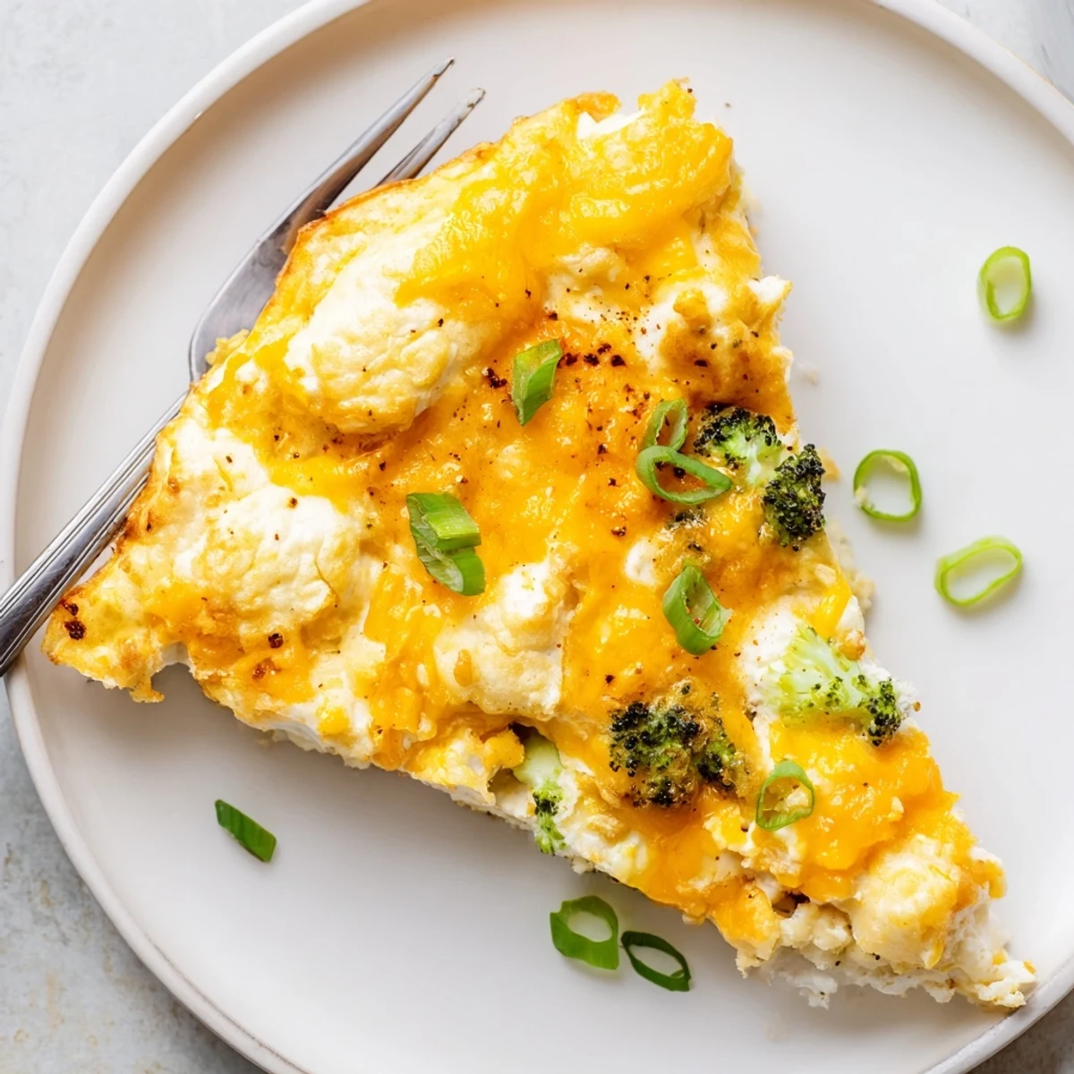 Slice of Cheesy Cottage Cheese Eggcloud Bake served with roasted tomatoes