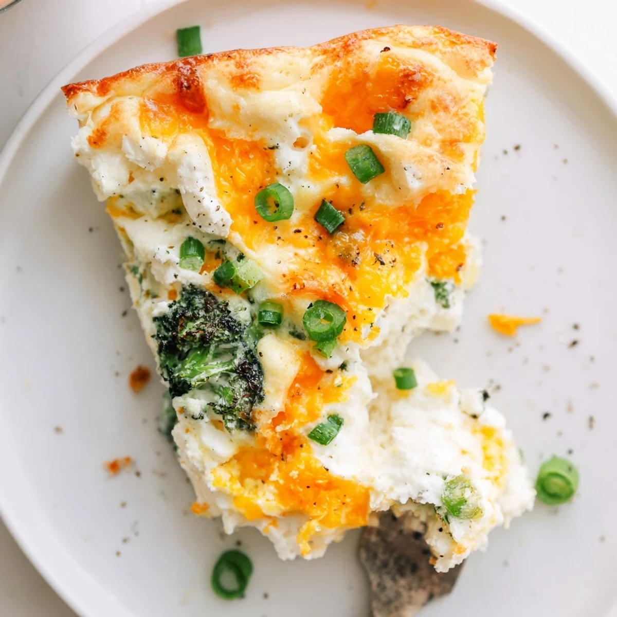 Steam rising from fluffy Cheesy Cottage Cheese Eggcloud Bake garnished with chives