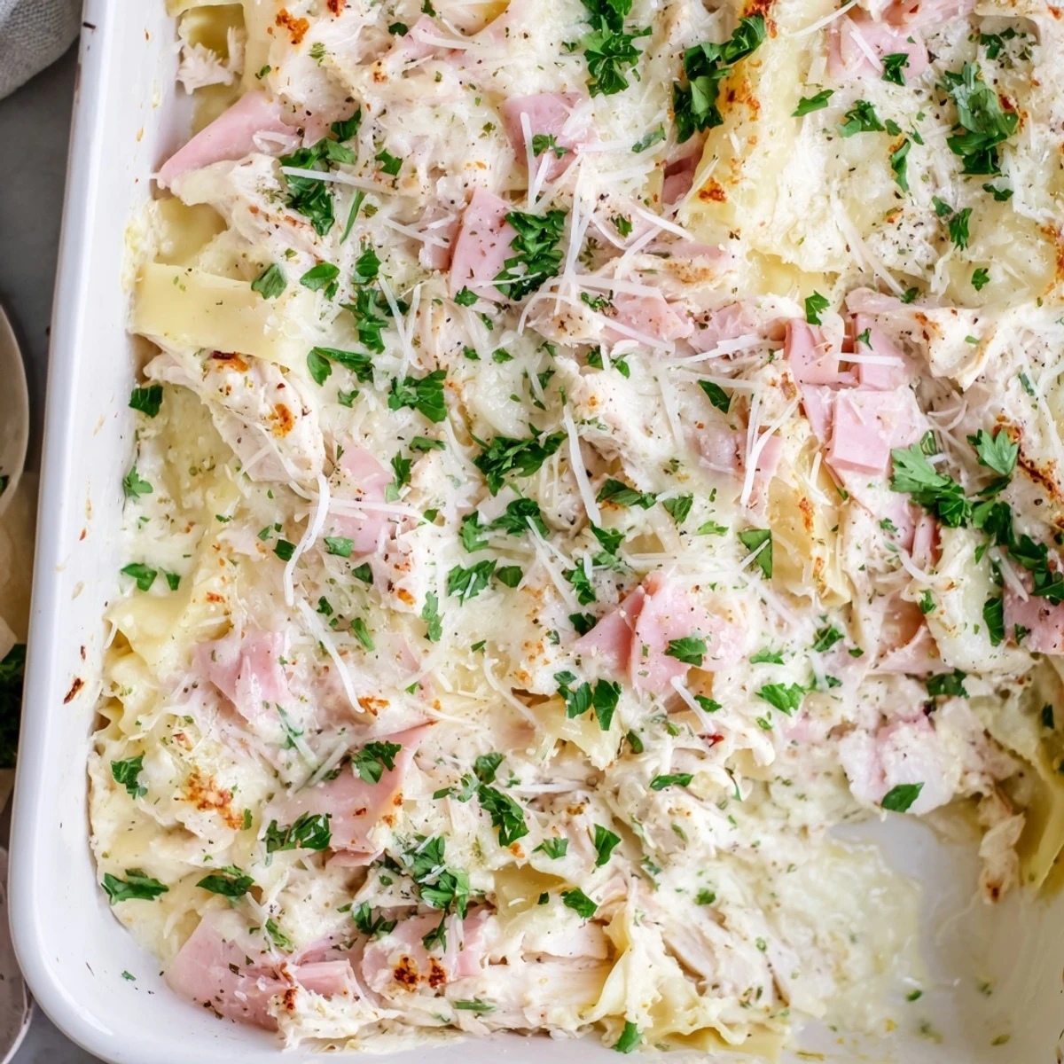 Golden bubbling Chicken Cordon Bleu Lasagna with melted Swiss and mozzarella cheese layers