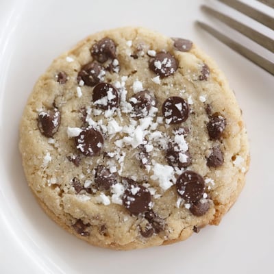 Freshly baked Peppermint Chocolate Chip Cookies steaming, chocolate melting, crushed candy cane garnish
