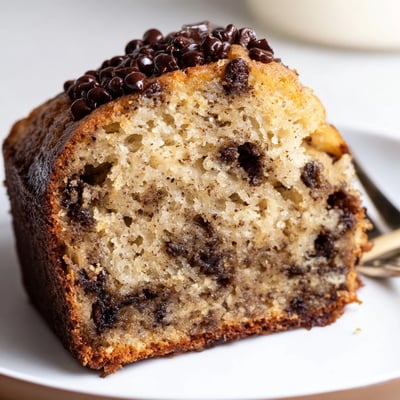 Sliced Banana Chocolate Chip Cake served warm with melting vanilla ice cream